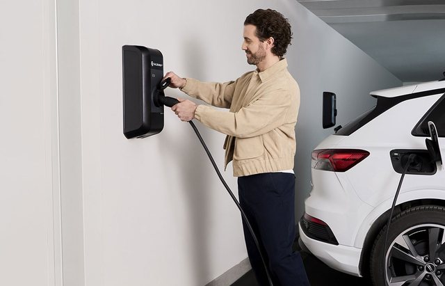 Electric car charging at a wallbox in an underground car park