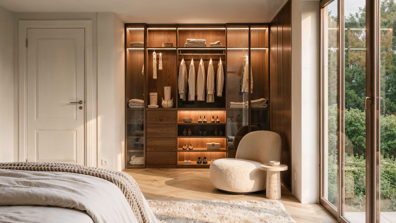 Visualisation of a bedroom with walk-in wardrobe and floor-to-ceiling window onto the greenery